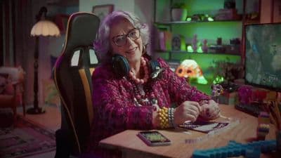 a woman sitting at a desk with headphones on