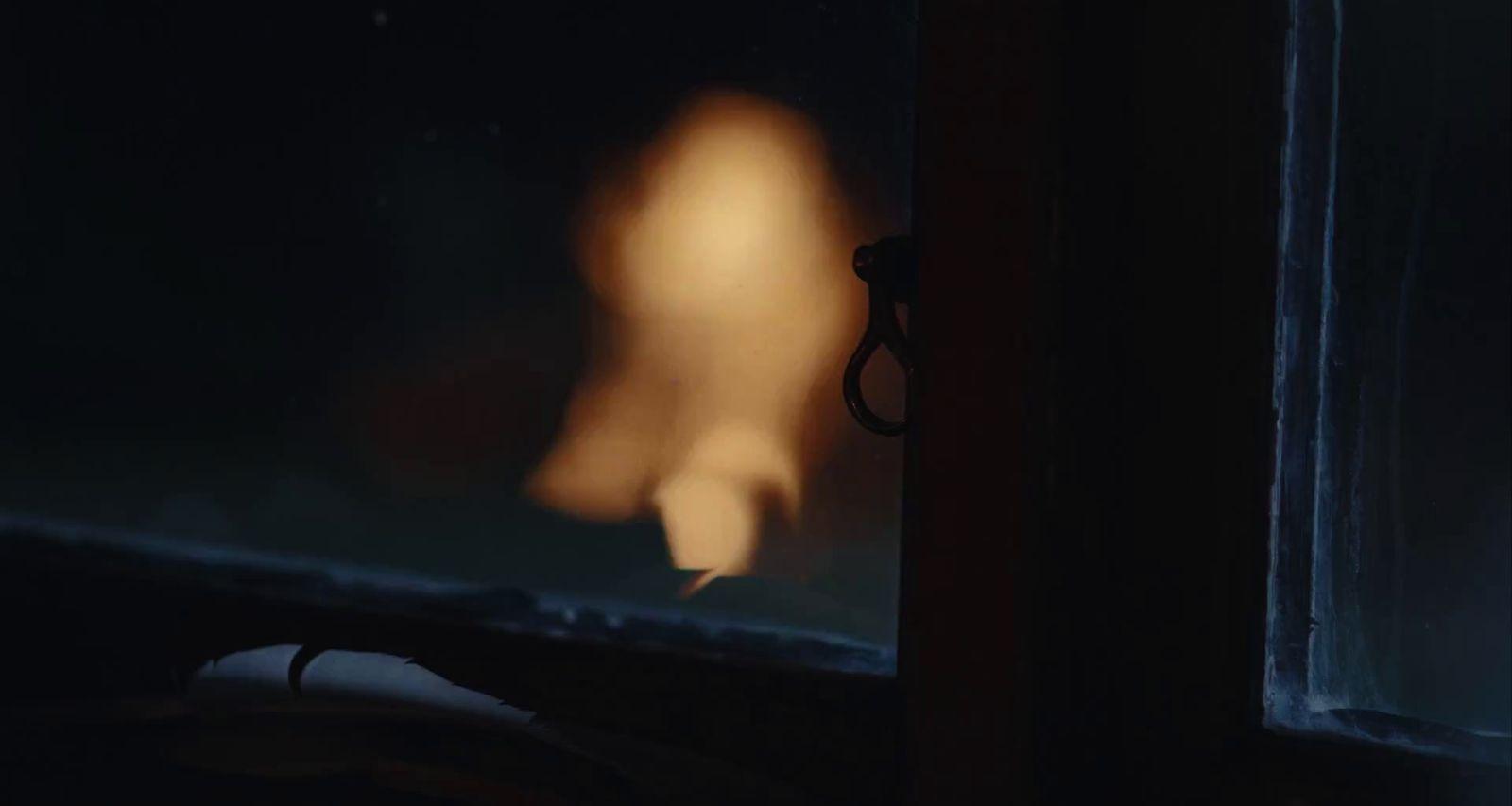 a blurry image of a person in a dark room