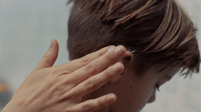 a person with their hand on their ear