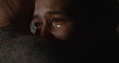 a close up of a person with a tear on their face