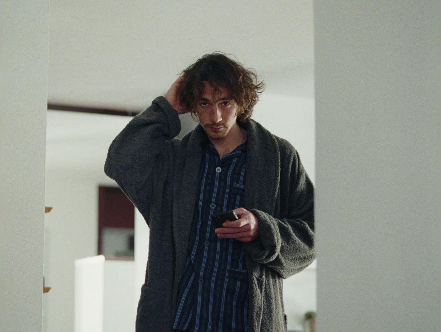 a man is looking at his cell phone