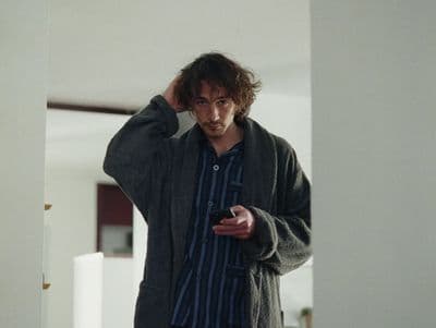a man is looking at his cell phone