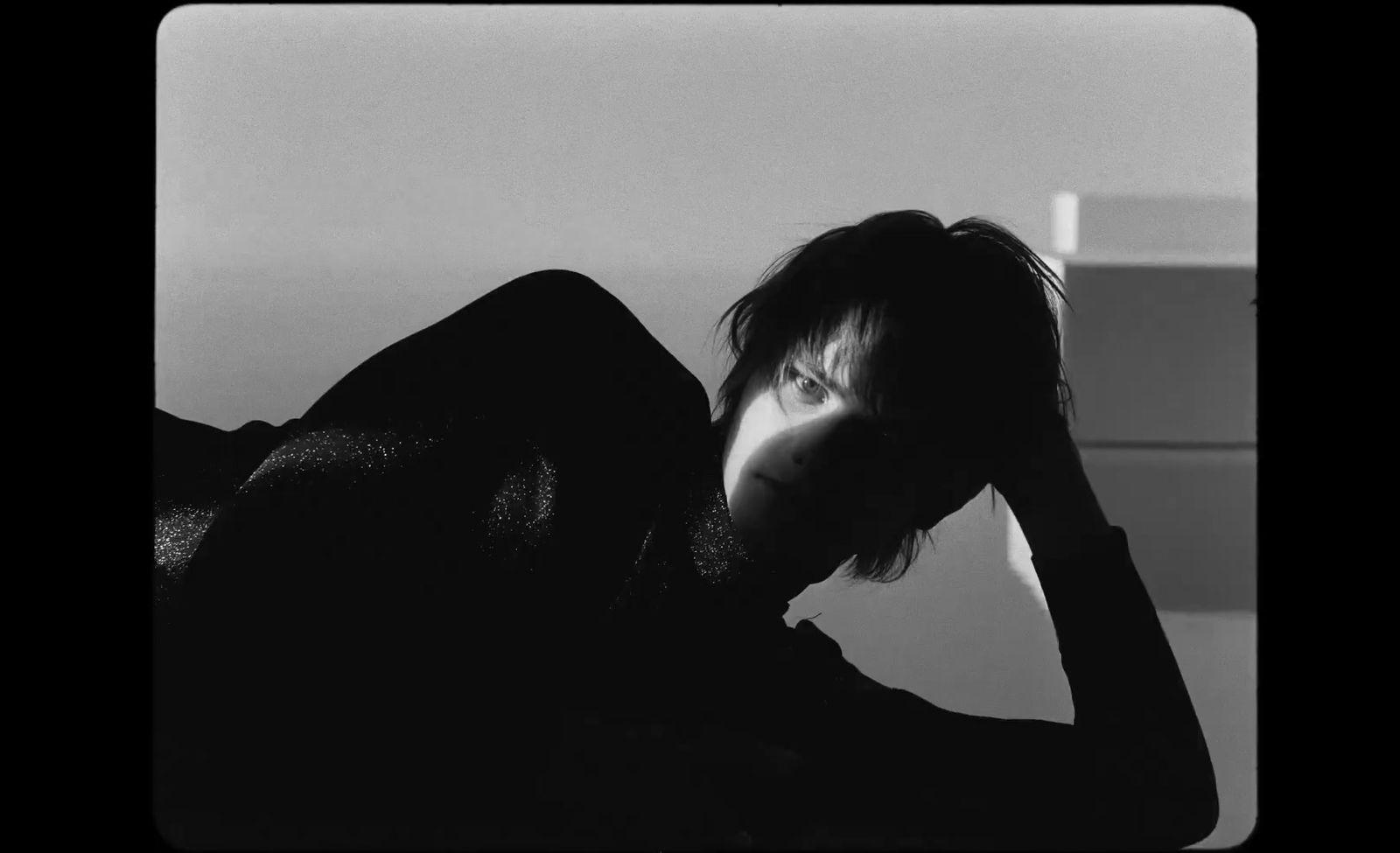 a black and white photo of a woman with her head in her hands