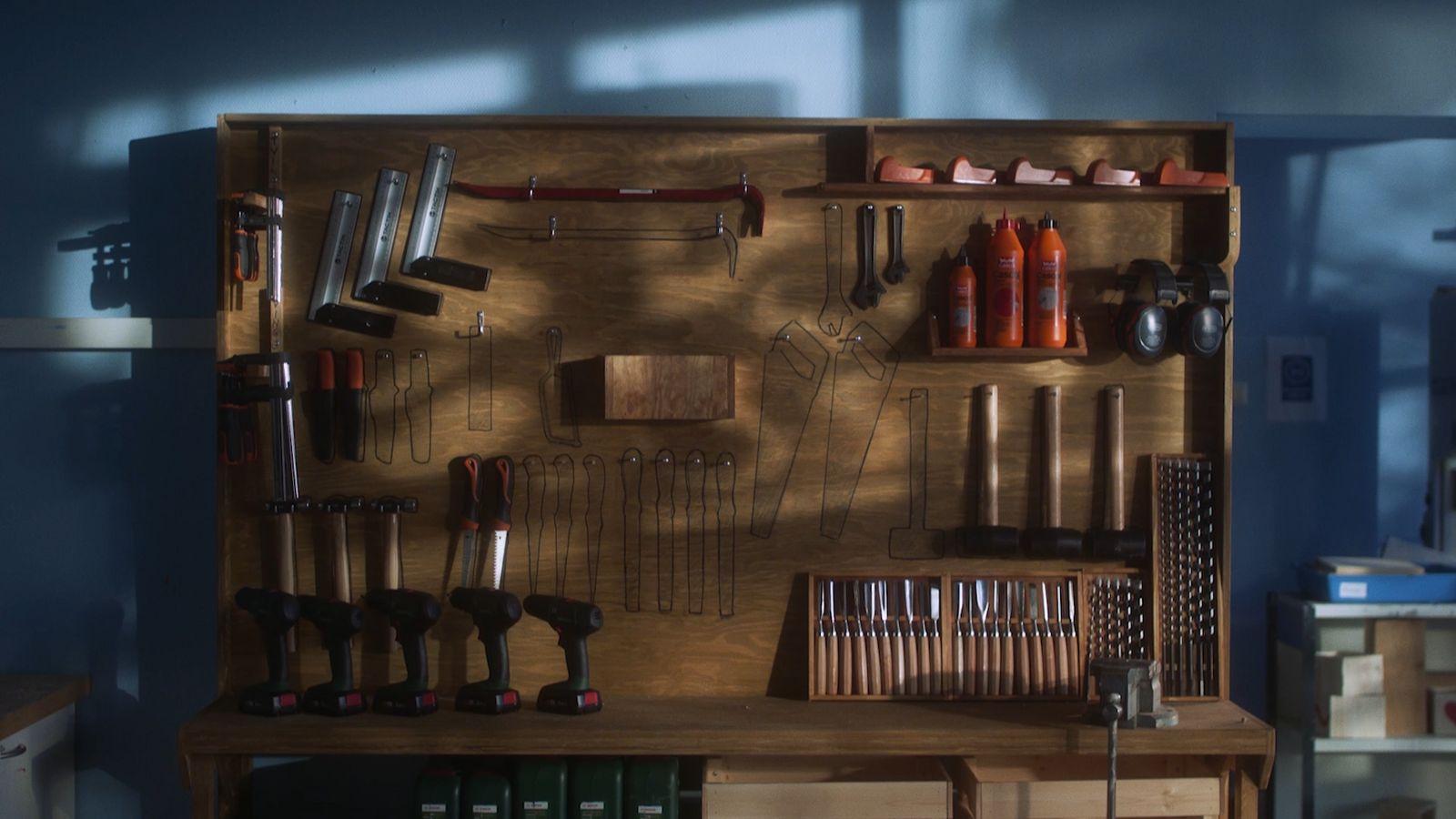 a wooden shelf filled with lots of tools