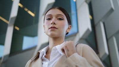 a woman standing in front of a building