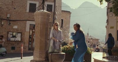 a couple of women standing next to each other on a street