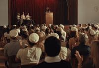 a crowd of people sitting in front of a podium