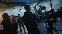 a group of people standing around a camera