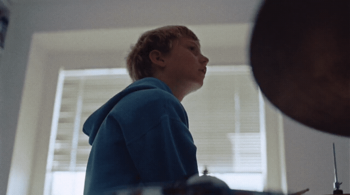 a woman standing in a kitchen next to a window