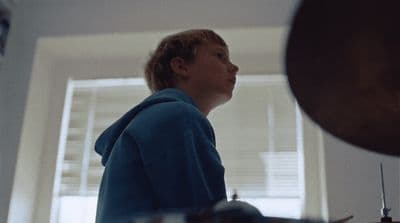 a woman standing in a kitchen next to a window