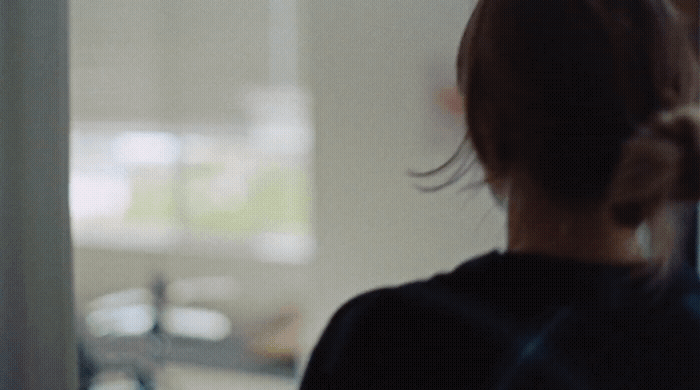 a woman standing in front of a window