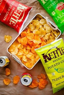 a couple of bags of potato chips next to a bag of chips