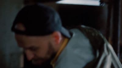 a man with a beard wearing a baseball cap