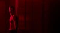 a man standing in front of a red light