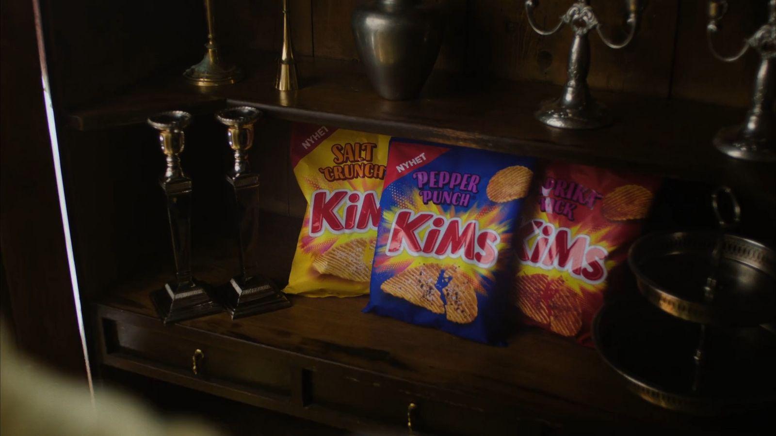 a couple of bags of chips sitting on top of a shelf