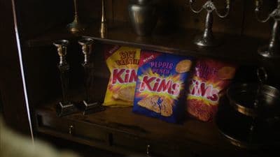 a couple of bags of chips sitting on top of a shelf