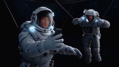a man in a space suit holding a cell phone