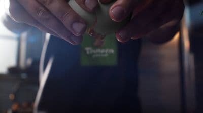 a person holding a piece of food in their hands