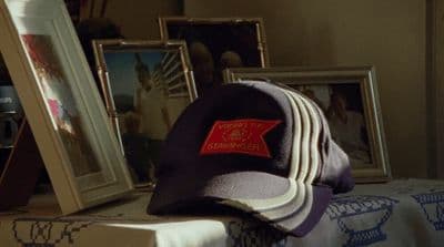 a hat sitting on top of a table next to pictures