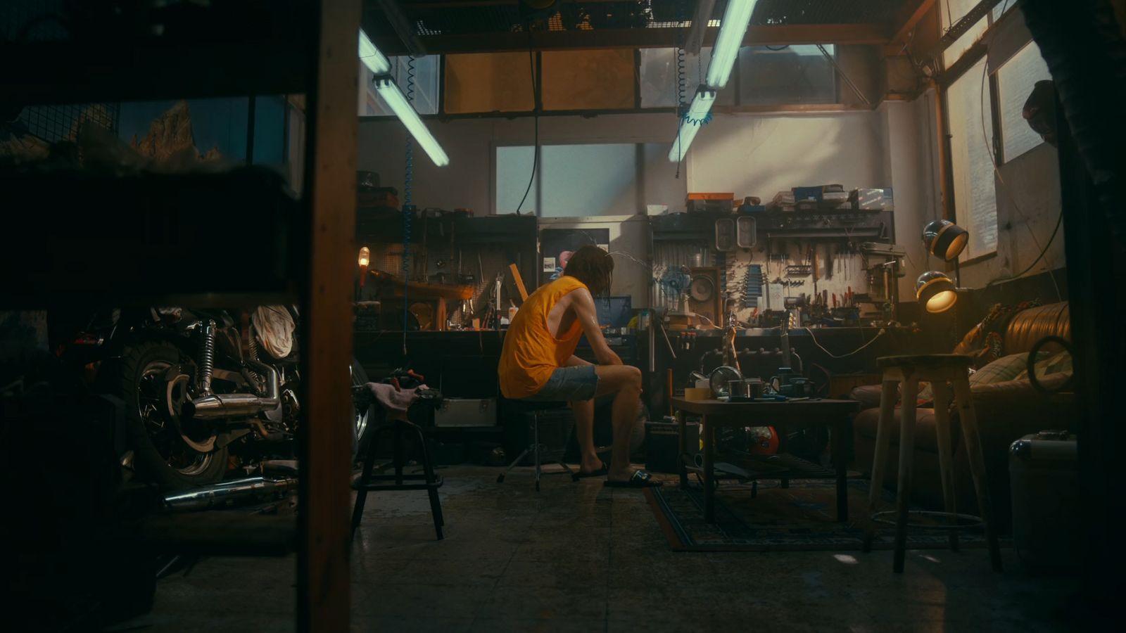 a person sitting in a room with lots of tools