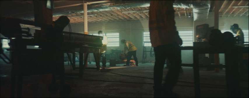 a group of people standing around a piano