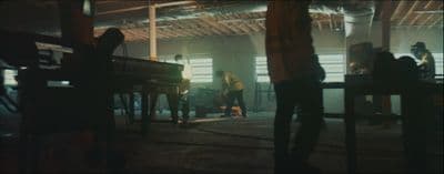 a group of people standing around a piano