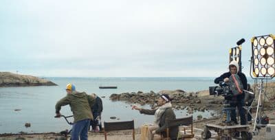 a group of people on a beach near a body of water