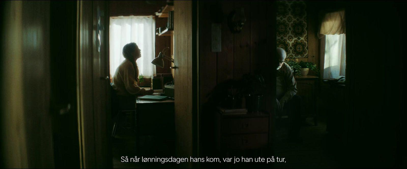 a woman standing in a kitchen next to a window