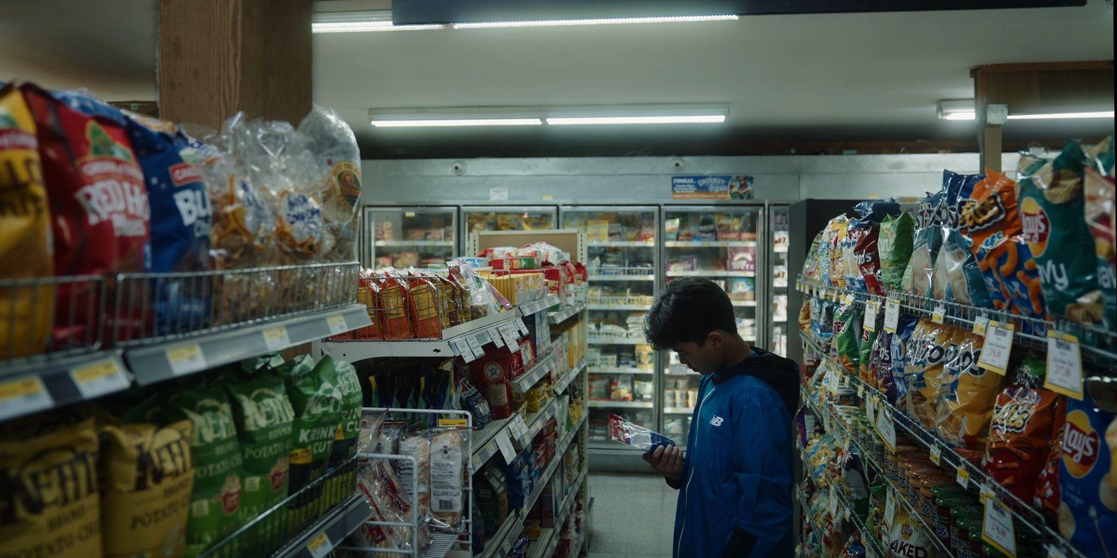 a person standing in a store looking at food