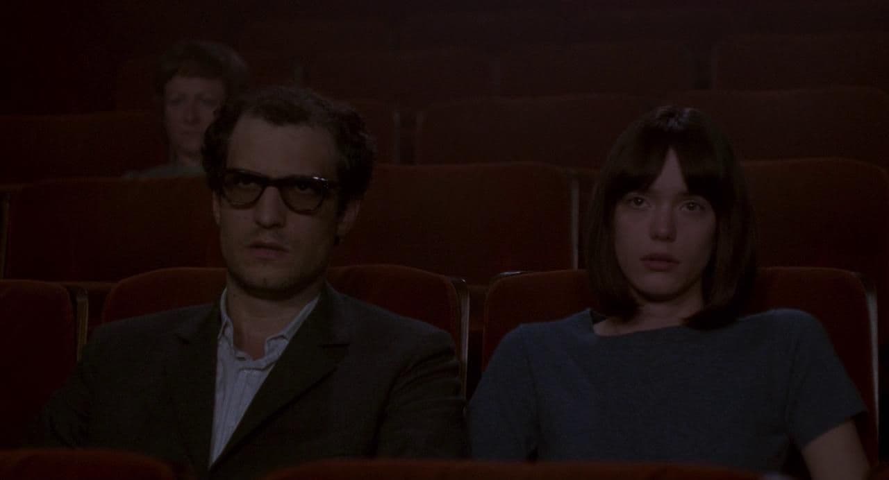 a man and a woman sitting in a theater