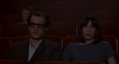 a man and a woman sitting in a theater