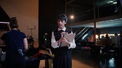 a man standing in a room holding a piece of paper