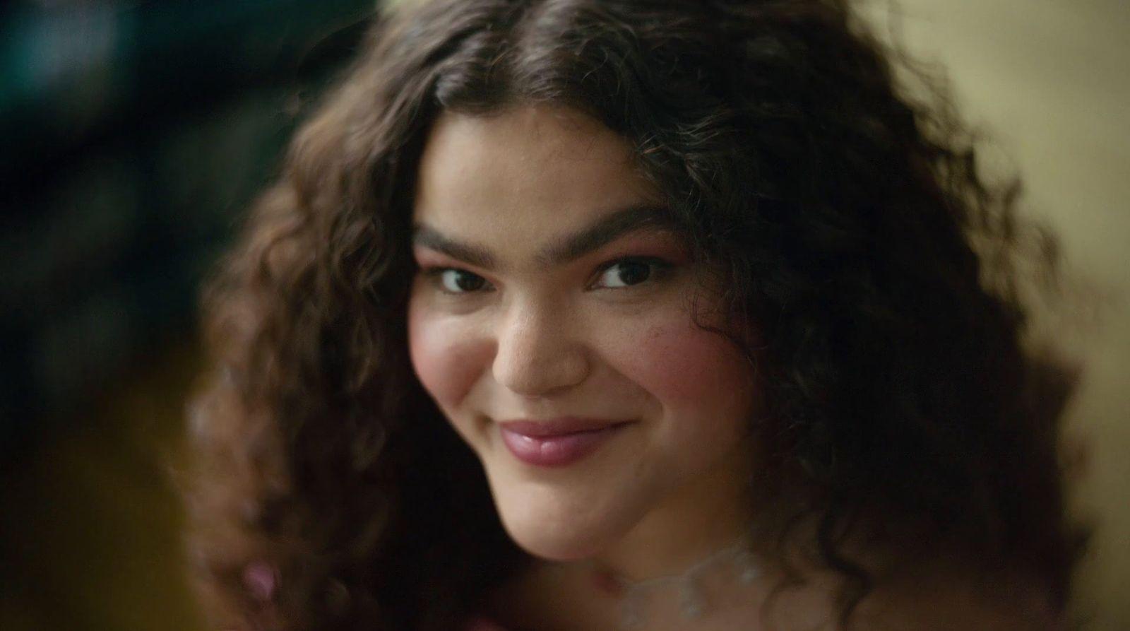 a close up of a person with curly hair