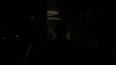a man standing in a dark room in the dark