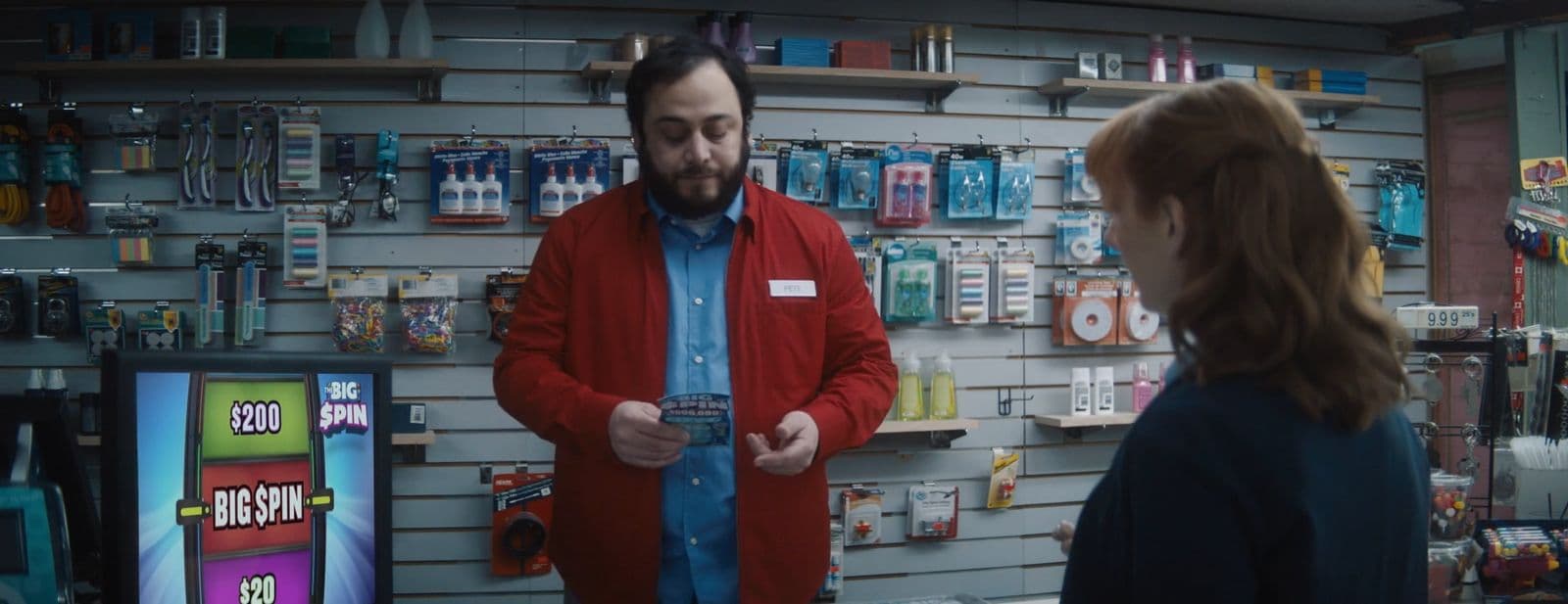 a man standing in front of a store talking to a woman
