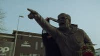 a statue of a man holding a baseball bat