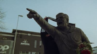 a statue of a man holding a baseball bat