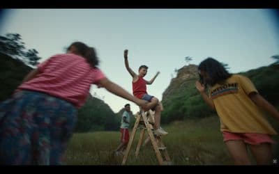 a group of people standing on top of a wooden ladder