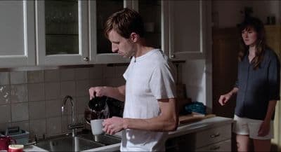 a man and a woman standing in a kitchen