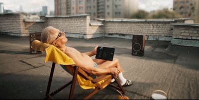 a man sitting in a chair on top of a roof