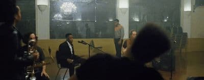 a group of people in a room with microphones
