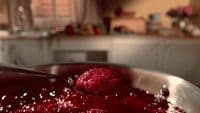 a spoon with a scoop of raspberry sauce on it
