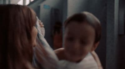 a woman holding a baby in her arms