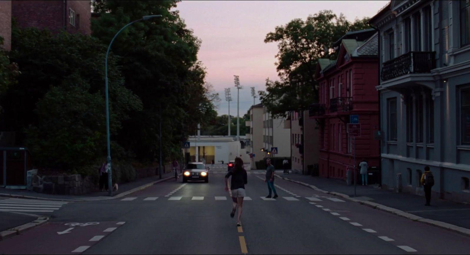 a couple of people walking across a street