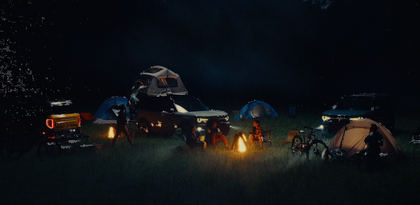 a group of people camping in the dark