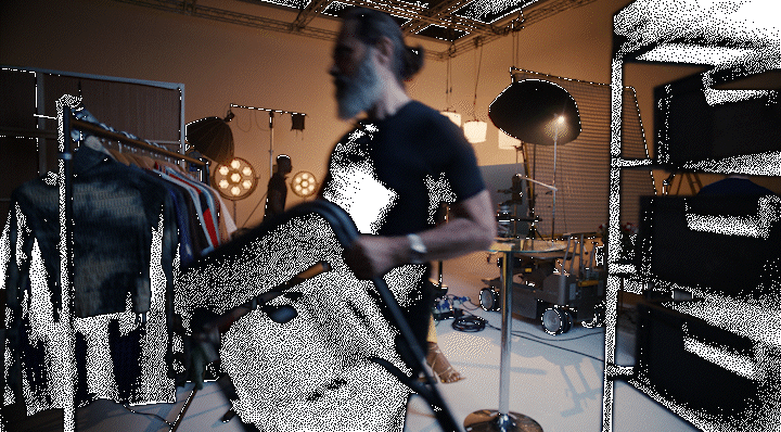 a man in a dark room with a vacuum in his hand