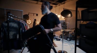 a man in a dark room with a vacuum in his hand