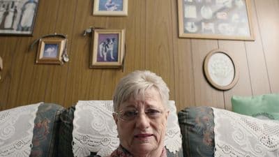 a woman sitting on a couch in a living room