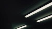 a black and white photo of lights in a dark room