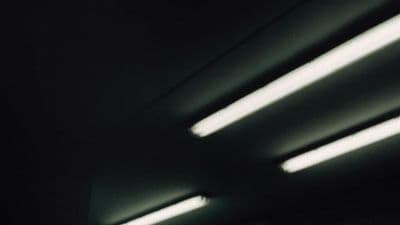 a black and white photo of lights in a dark room